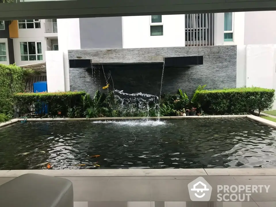 Luxurious garden view with serene water feature in modern residential complex