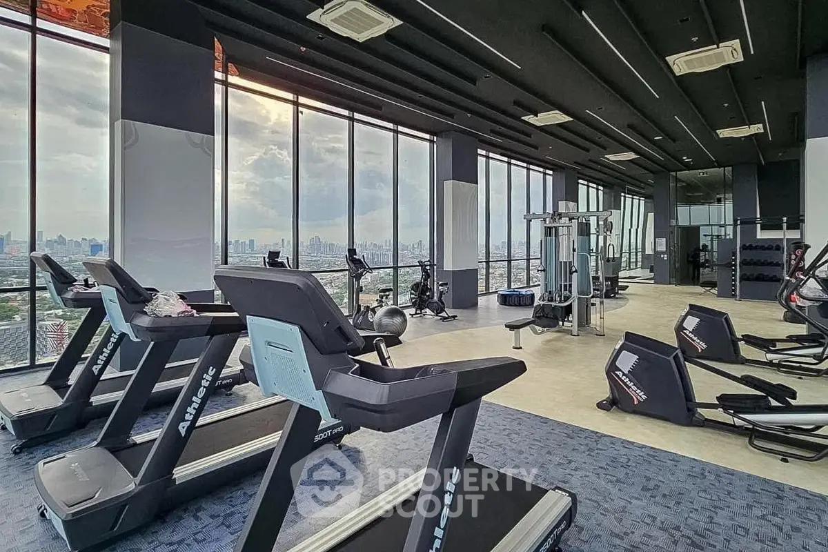 Modern gym with panoramic city views and state-of-the-art equipment.