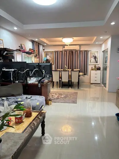 Spacious living and dining area with elegant decor and modern lighting.