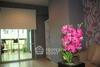 Stylish living room with vibrant pink flowers and modern decor