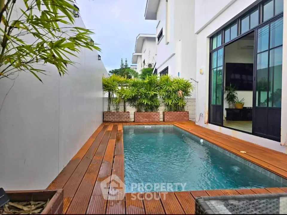 Luxurious private pool with wooden deck in modern residential property