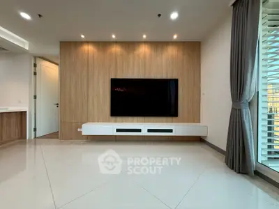 Modern living room with sleek TV setup and elegant wood paneling
