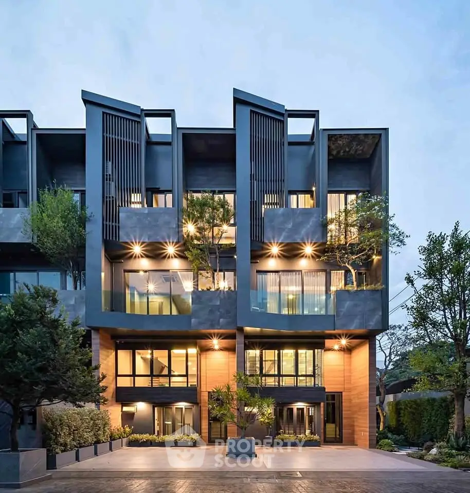 Modern architectural building with sleek design and lush greenery, showcasing contemporary urban living.