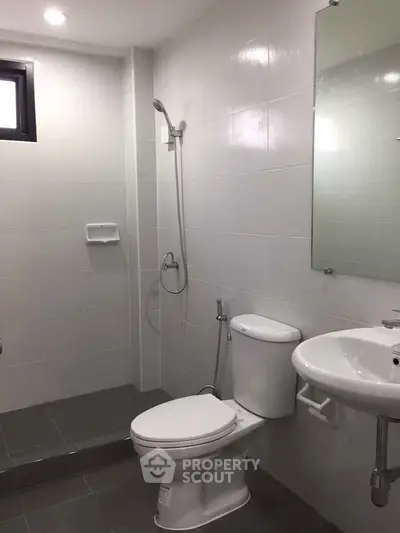 Modern bathroom with sleek fixtures and walk-in shower in a contemporary home.