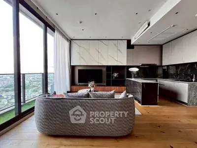 Luxurious modern living room with panoramic city view and sleek kitchen design.