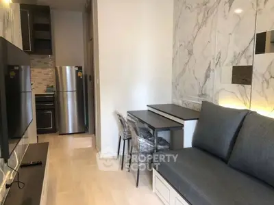 Modern compact living room with sleek kitchen and marble accents