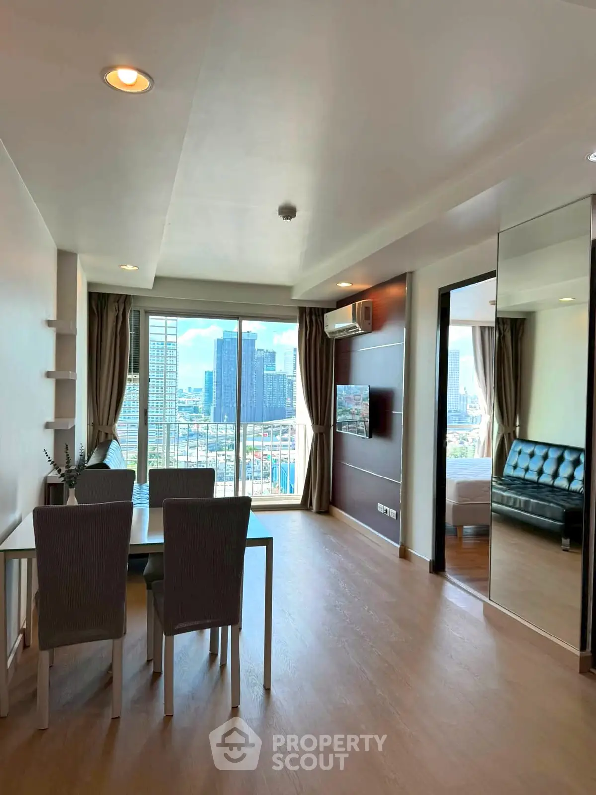 Spacious modern living room with city view, elegant dining area, and sleek furnishings in a high-rise apartment.