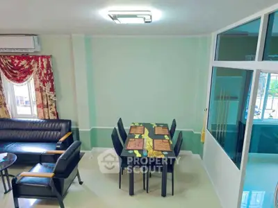 Spacious living room with elegant dining area and modern furniture in a stylish apartment.