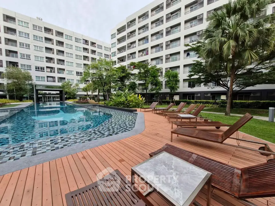 Luxurious apartment complex with a stunning pool and lush greenery, perfect for relaxation and leisure.
