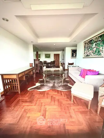 Spacious living room with elegant hardwood flooring and stylish furniture