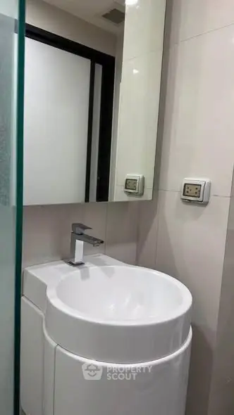 Modern bathroom with sleek white sink and minimalist design