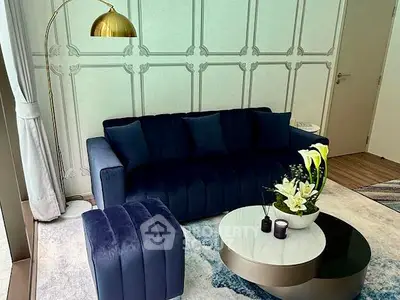 Elegant living room with plush navy sofa and stylish decor
