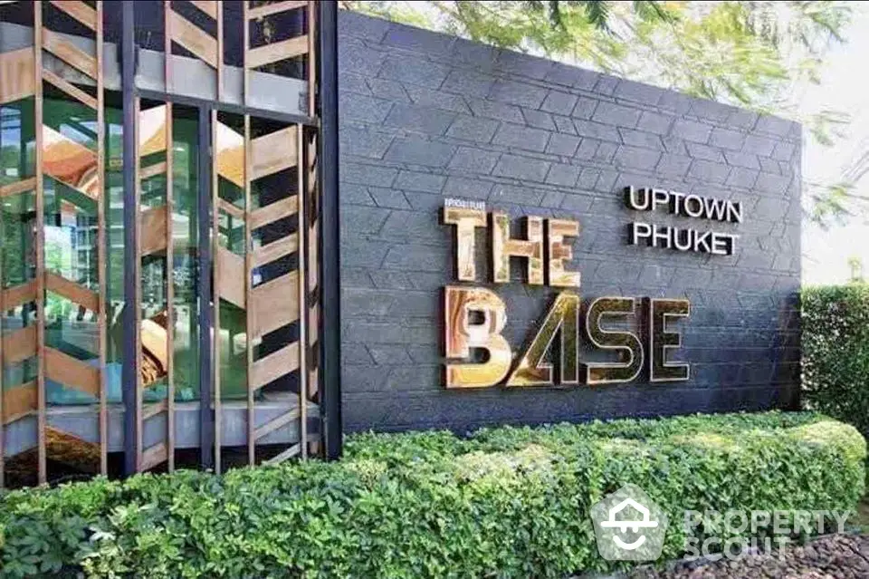 Modern exterior of The Base Uptown Phuket with lush greenery and stylish architecture.