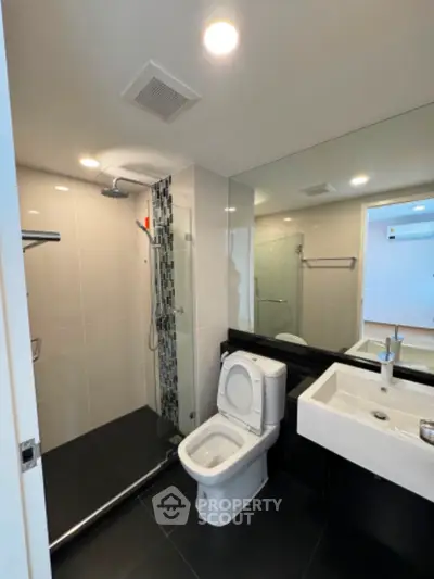 Modern bathroom with sleek fixtures and glass shower enclosure