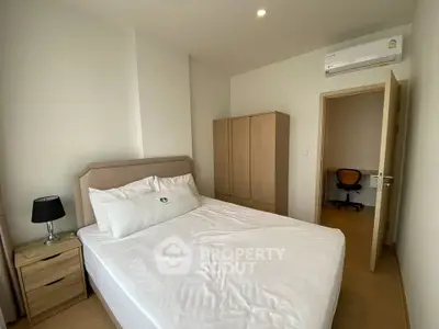 Cozy bedroom with modern furnishings and air conditioning, perfect for a comfortable living experience.