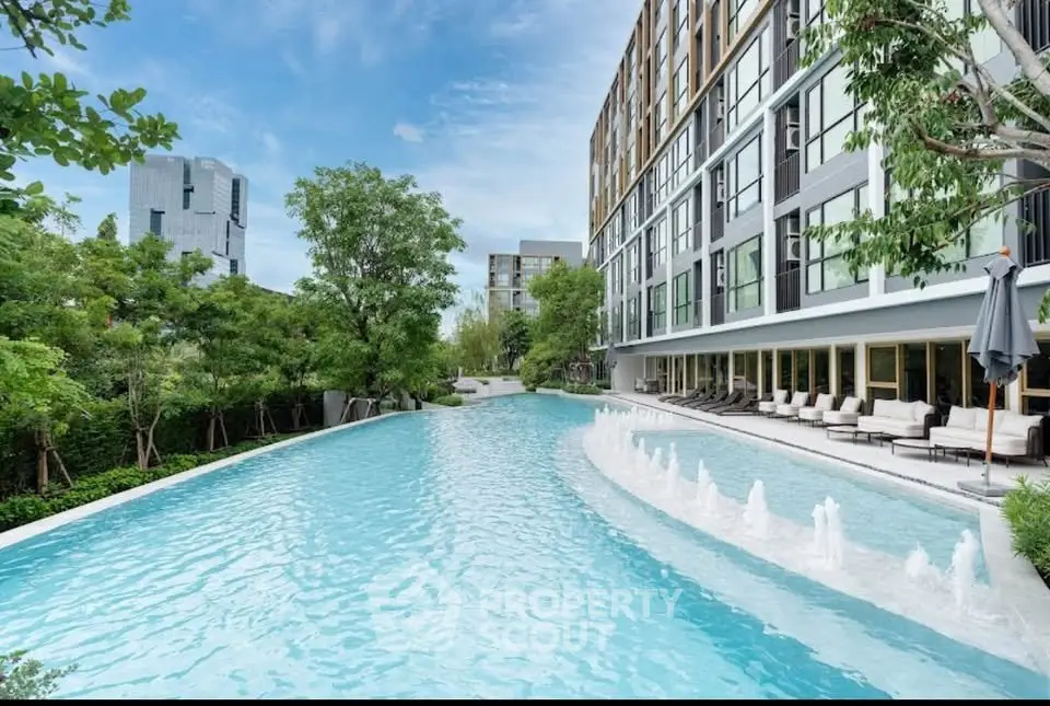 Luxurious residential building with stunning pool and lush greenery