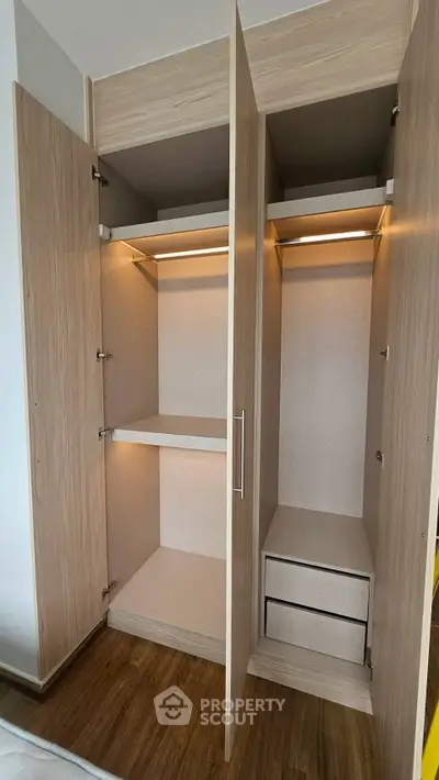 Spacious wooden wardrobe with open doors showcasing ample storage space and modern design.