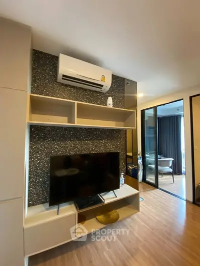 Modern living room with sleek entertainment center and air conditioning unit
