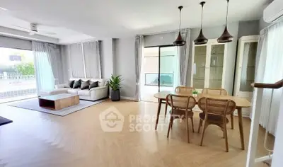 Spacious modern living room with dining area and large windows