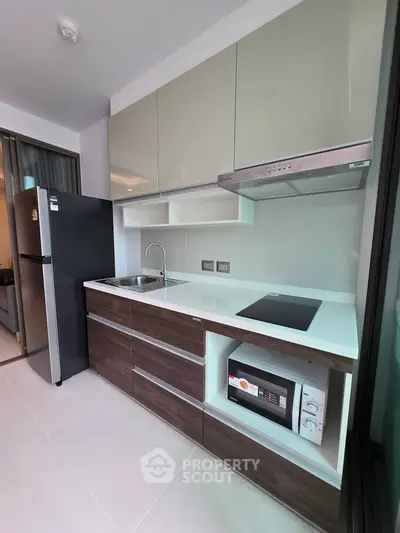 Modern kitchen with sleek cabinetry, built-in appliances, and minimalist design in a contemporary apartment.
