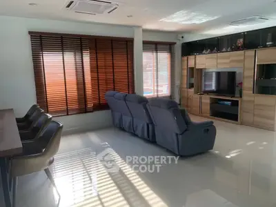 Spacious living room with modern furniture and large windows for natural light.