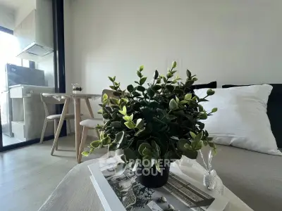 Modern living room with stylish decor and open kitchen layout, perfect for urban living.