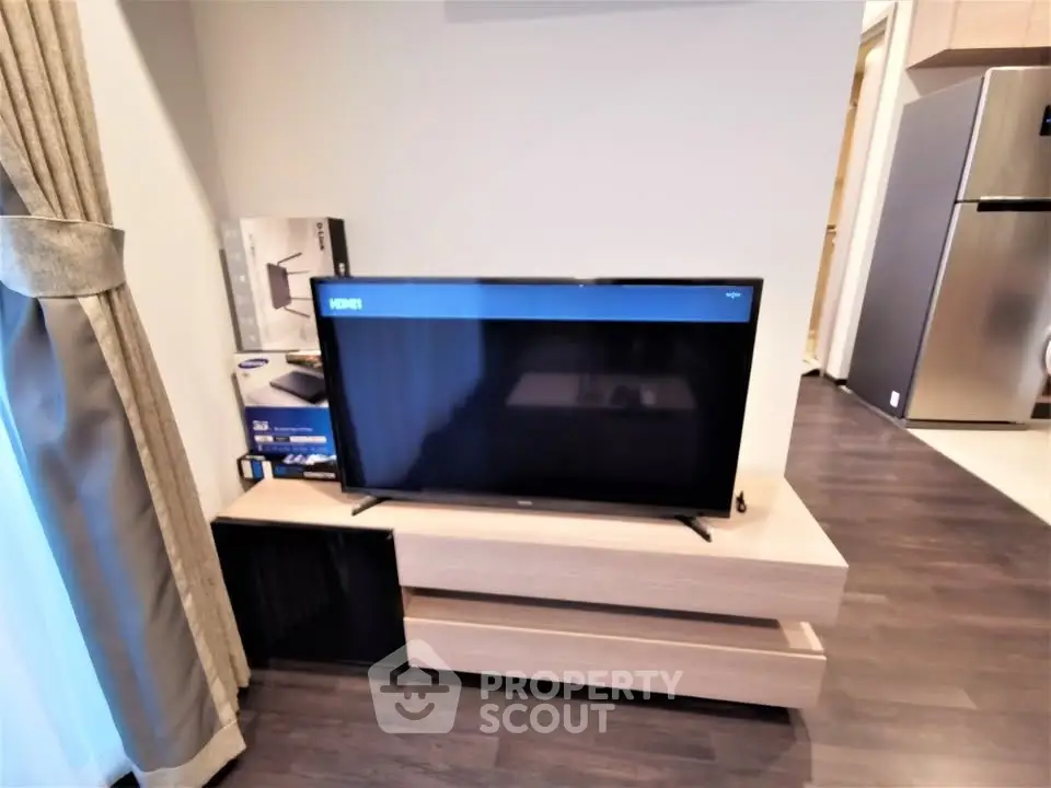 Modern living room with sleek TV setup and stylish wooden flooring