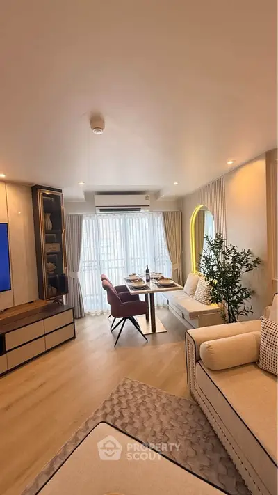 Modern living room with elegant decor, large windows, and stylish furniture in a cozy apartment.
