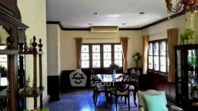 Elegant dining room with classic wooden furniture and large windows