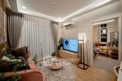 Modern living room with stylish decor and cozy ambiance, featuring a TV and air conditioning.