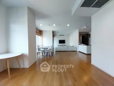 Spacious modern living room with wooden flooring and elegant dining area