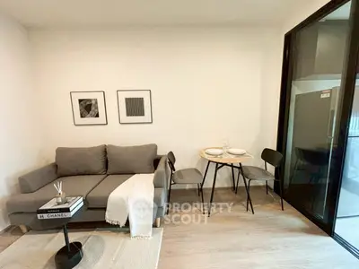 Modern living room with cozy gray sofa and stylish dining area