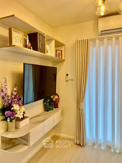 Chic living room with modern decor, wall-mounted TV, and elegant shelving.