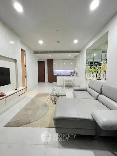 Modern living room with sleek white decor and cozy sectional sofa