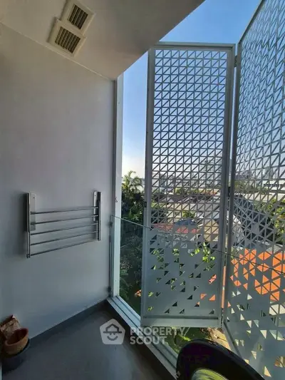 Modern balcony with geometric privacy screen and city view