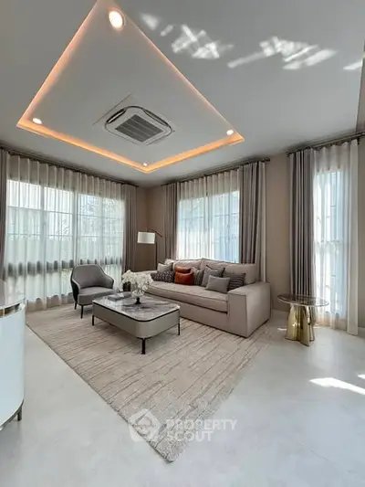 Elegant living room with modern decor and large windows