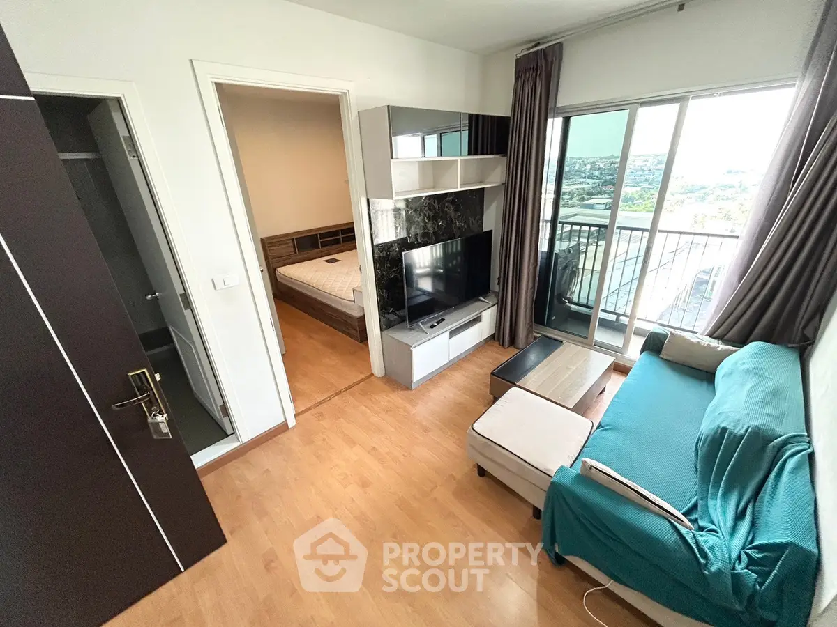 Modern living room with balcony view and stylish furniture in a cozy apartment.