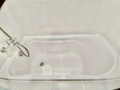 Spacious bathtub in modern bathroom with elegant tile design