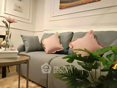 Stylish living room with plush sofa, elegant decor, and cozy ambiance.
