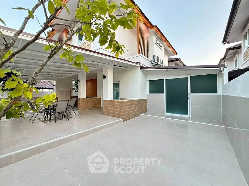 Spacious modern patio with outdoor dining area and sleek tiled flooring