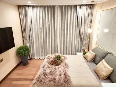 Luxurious bedroom with elegant decor and plush bedding, featuring floor-to-ceiling curtains and modern lighting.