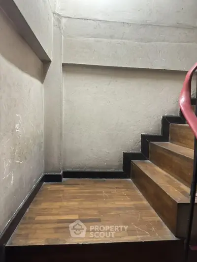 Well-maintained wooden staircase in a modern residential building, showcasing the durable materials and solid construction.