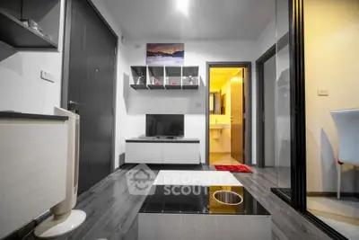 Modern living room with sleek furniture and open view to bathroom