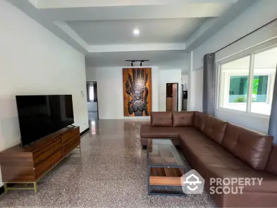 Spacious modern living room with large sectional sofa and wall art