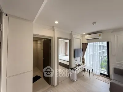 Modern apartment interior with open living space and bedroom view