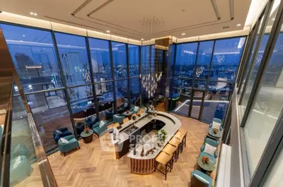 Luxurious penthouse with panoramic city views and elegant interior design.