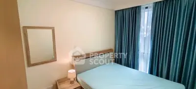 Cozy bedroom with natural light and modern furnishings, perfect for relaxation.