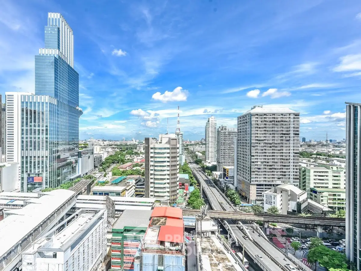 Stunning cityscape view from a high-rise building showcasing modern architecture and vibrant urban life.