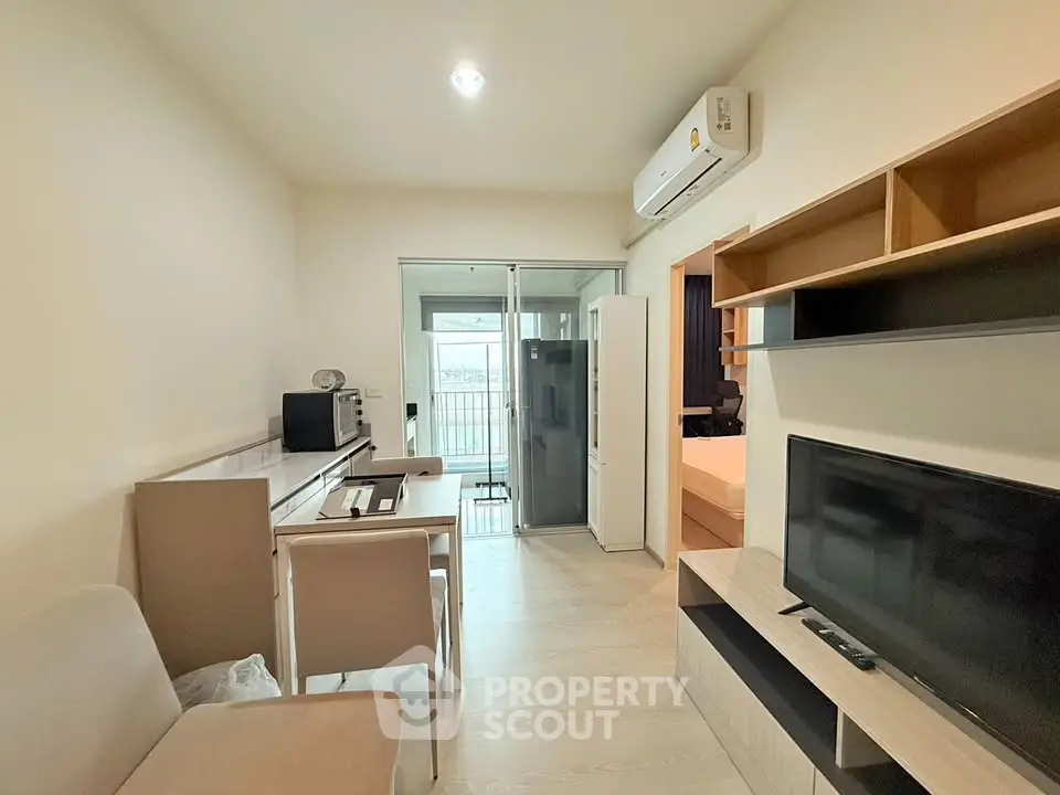 Modern living room with sleek furniture and balcony access in a stylish apartment.