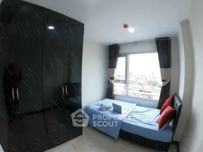 Cozy bedroom with city view, featuring a sleek black wardrobe and comfortable bed.